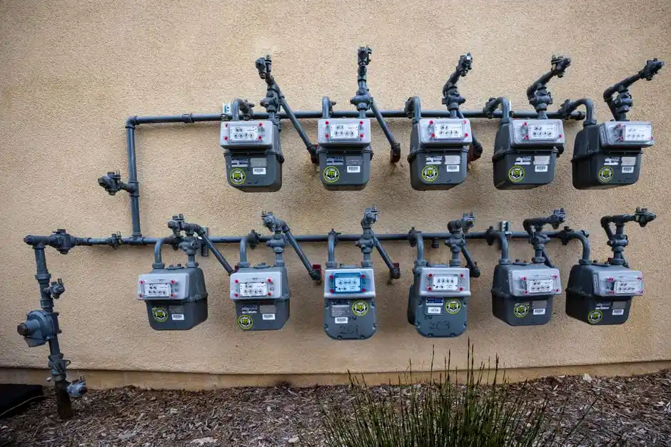New gas meters and piping installed on the exterior wall of a Apex NC home